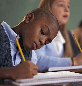 boyinclassroomtakingnotes