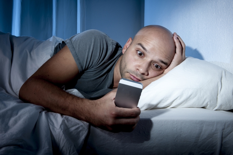 man addicted smartphone bed