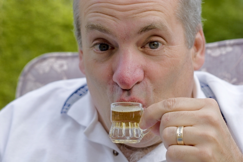 man drinking small beer