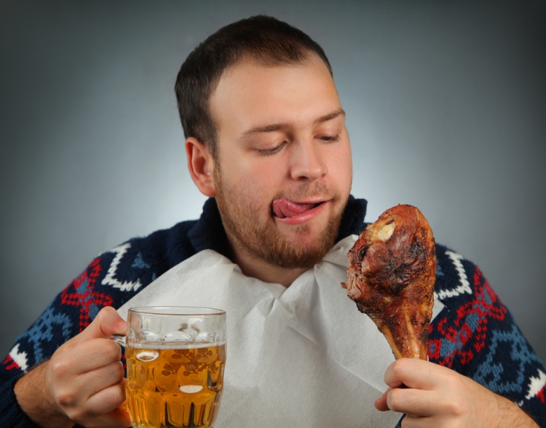 man eating turkey drinking beer