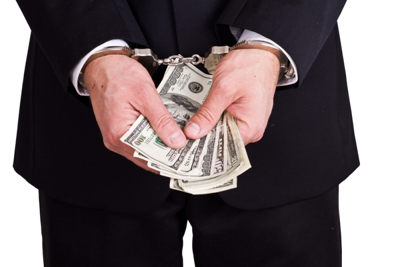 businessman cuffs money