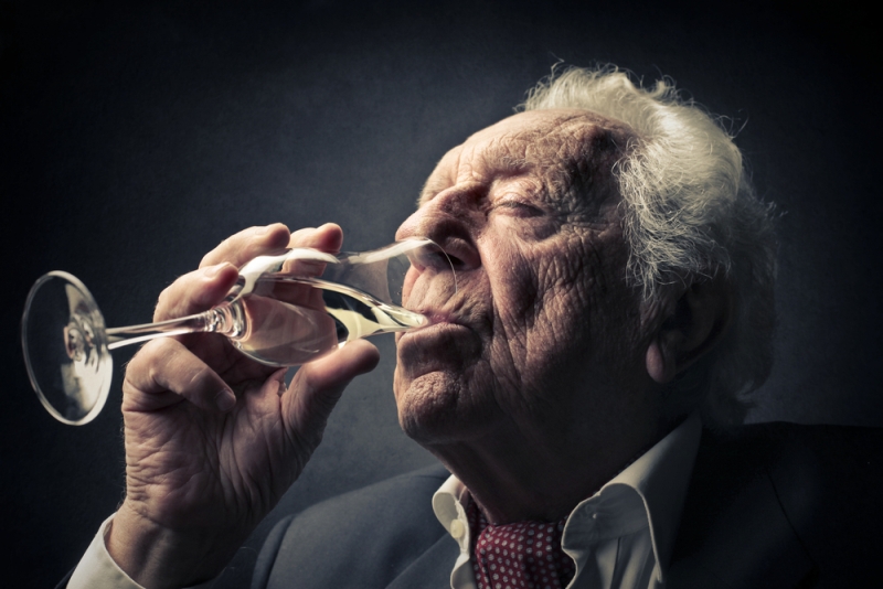 elderly man drinking champagne