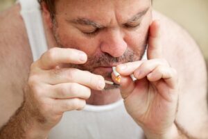 overweight man smoking joint
