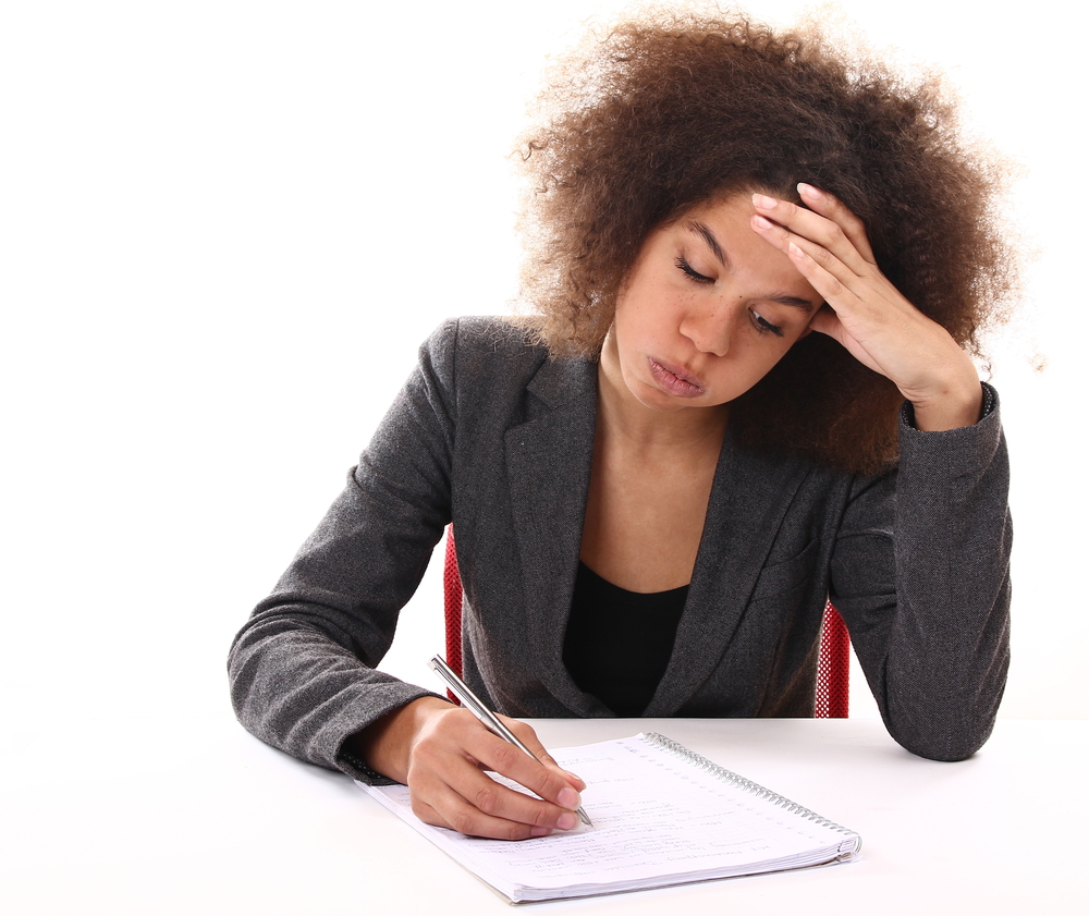 Woman writing on paper.