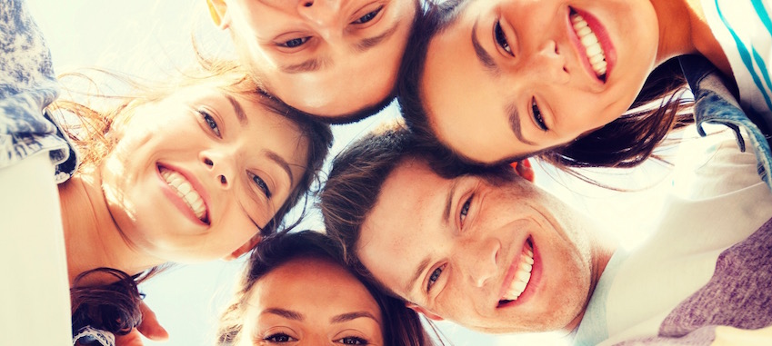 A group of smiling faces looking down at the camera.