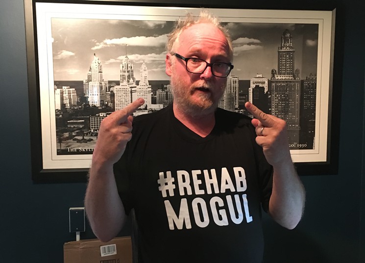 Chris Bathum wearing a tee-shirt saying "Rehab Mogul" and giving the finger to the camera.