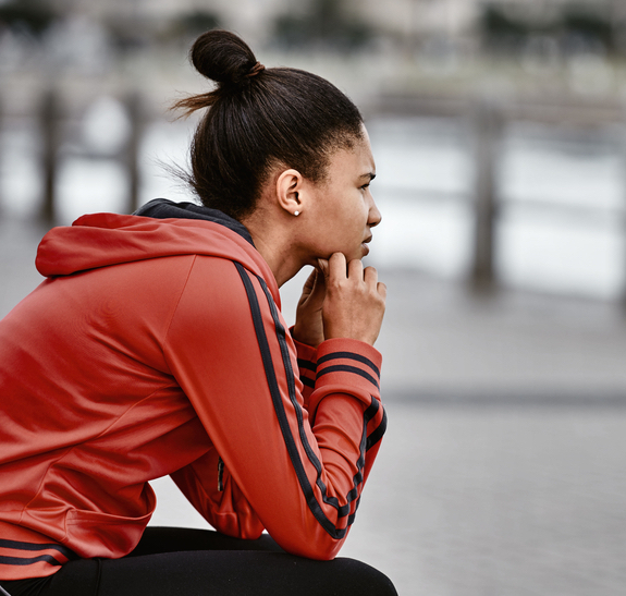Young woman sitting and thinking.
