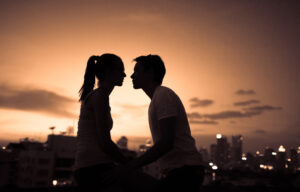 Silhouette of a man and woman in front of a sunset