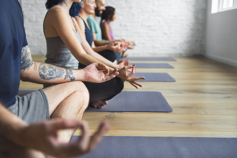A group of people sitting cross-legged and meditating