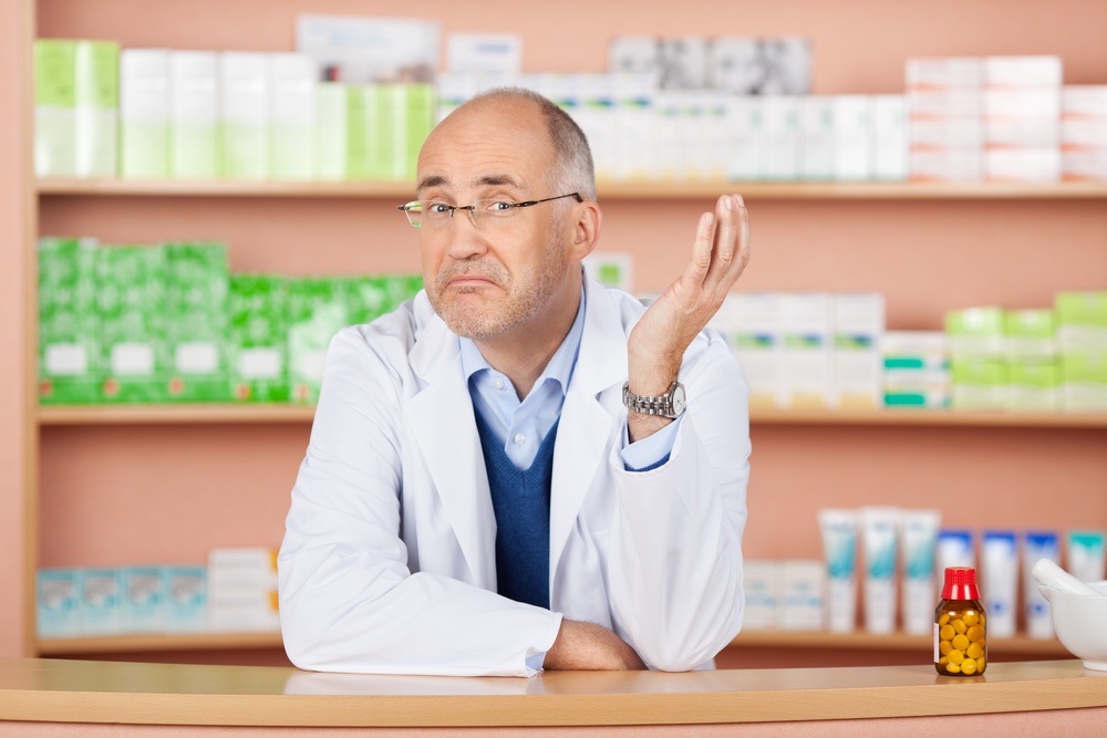 A pharmacist with a "so what" face and hand up