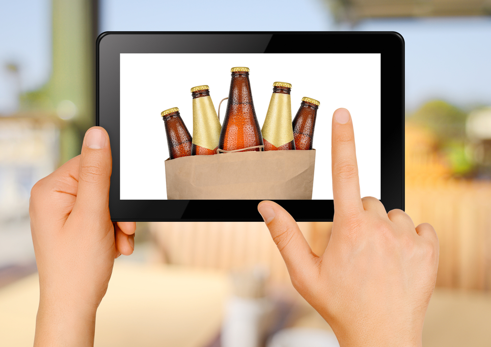 Person looking at alcohol on tablet device.