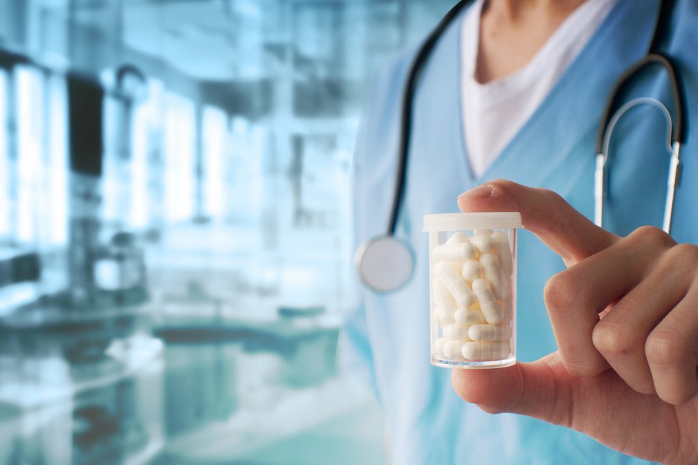 Doctor holding a bottle of pills.