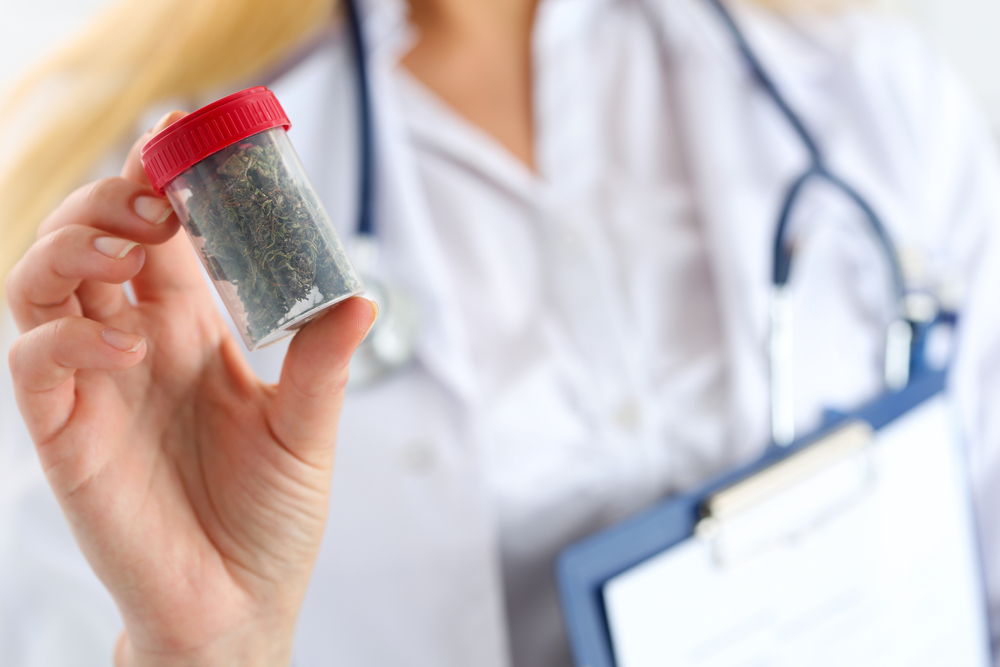 Doctor holding bottle of medical marijuana