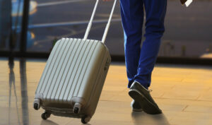 Man with suitcase at airport.