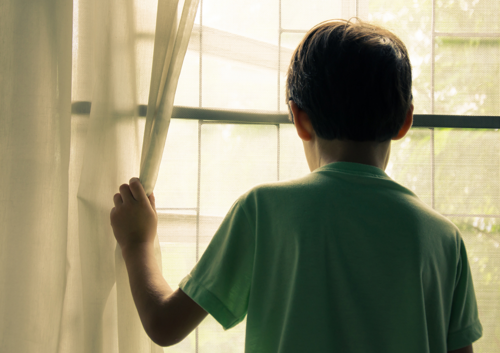 Boy looking out of window.