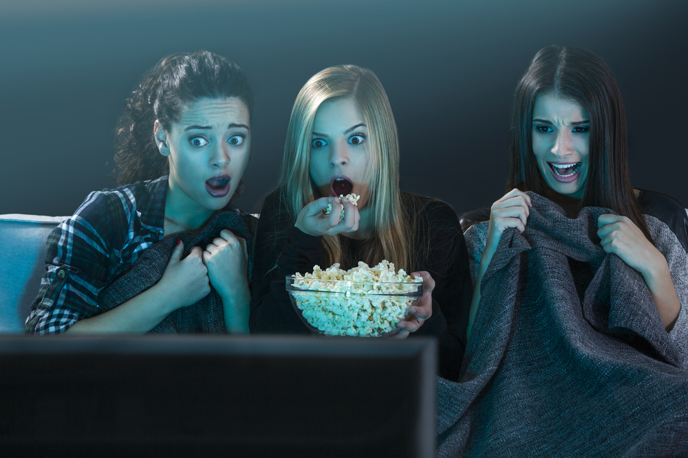 Women watching a scary movie.