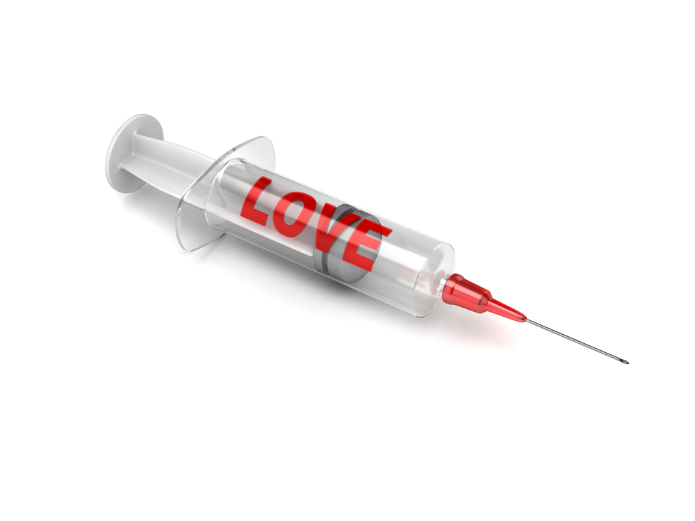A syringe with the word "LOVE" on the side.