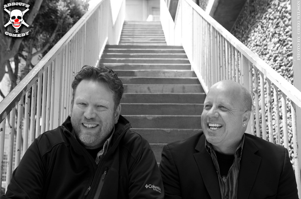 Kurtis Matthews and Mark Lundholm sitting on a staircase, black and white