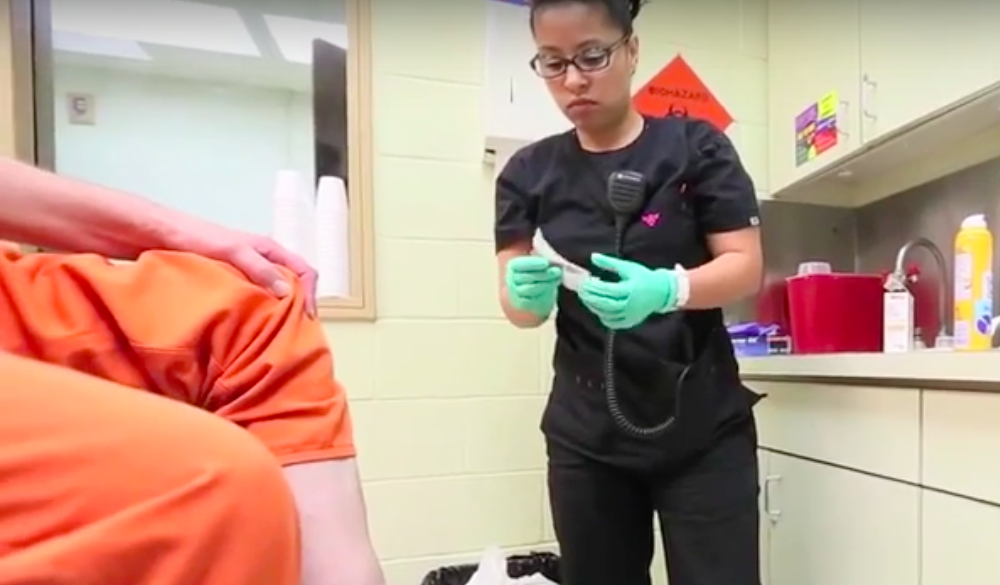 A nurse helping an inmate.