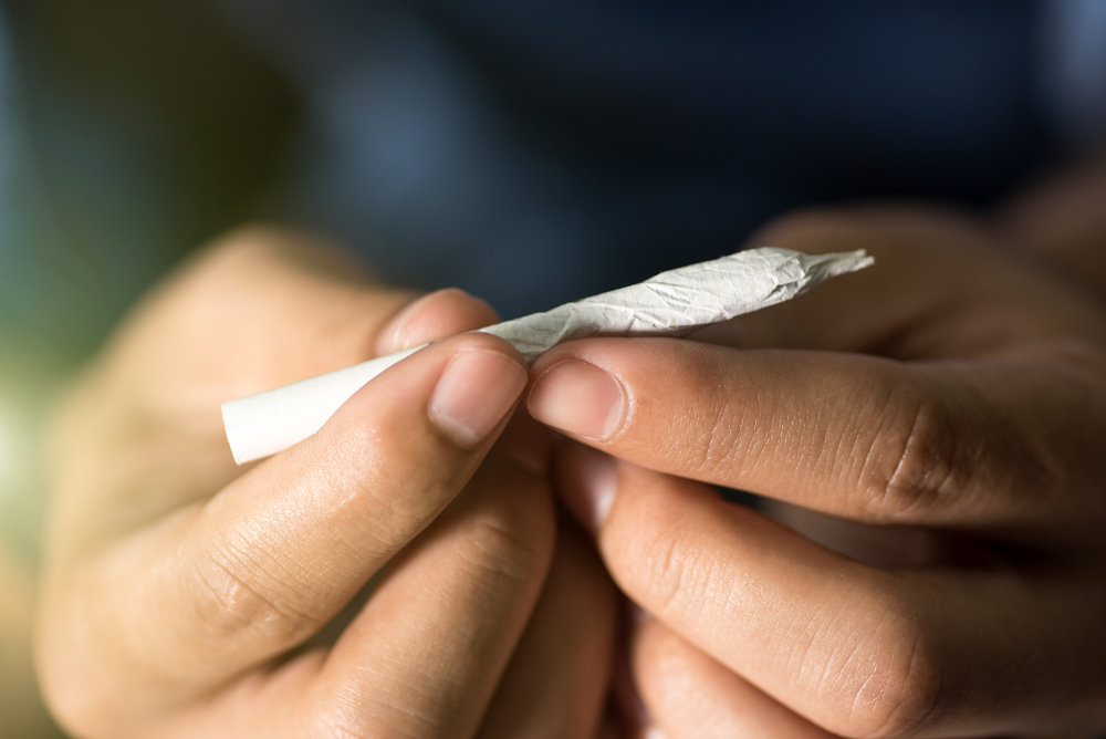 close-up of a hand-rolled joint.