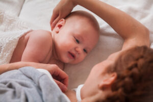 A mother lying with her child.