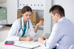A doctor writing a prescription for a patient.