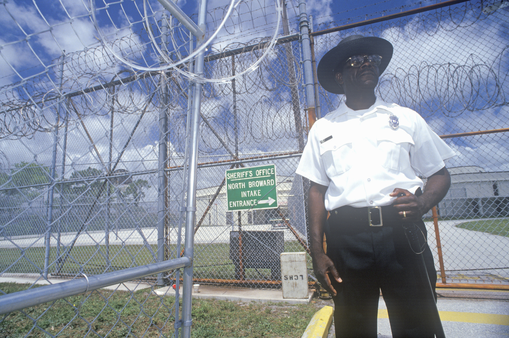 A guard standing outside a Dade County prison.