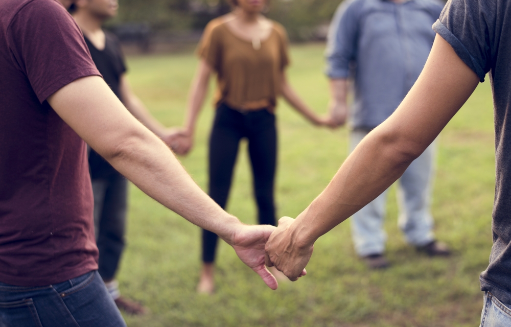 A group of people in a circle holding hands