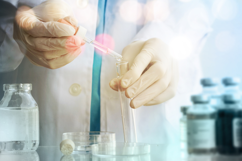 a chemist testing a liquid in a laboratory.