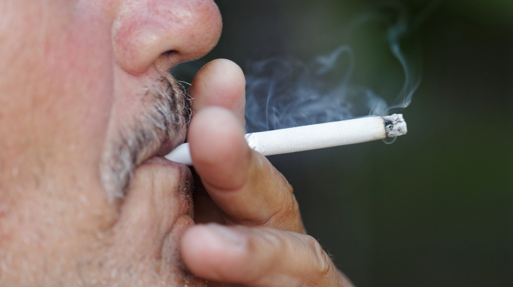 Close up of man smoking a cigarette