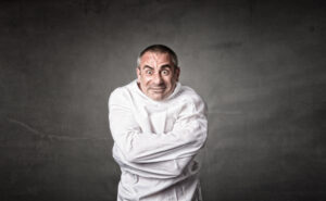 Man in strait jacket on a dark background.