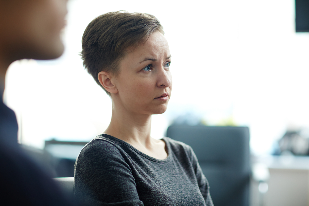 young worried woman at group meeting