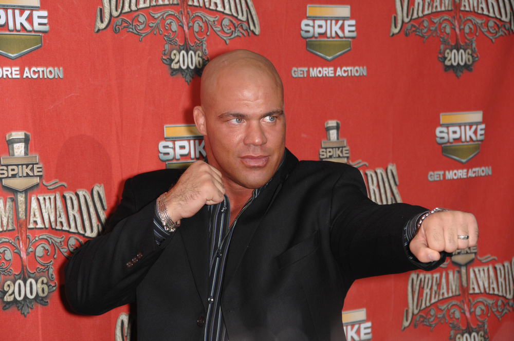 Kurt Angle posing with fists in front of red