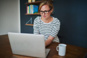 woman sitting in front of laptop in office