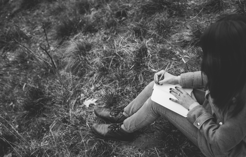 girl writing in journal black and white