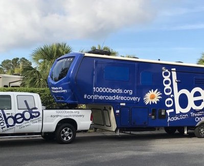 Truck towing 10,000 Beds trailer