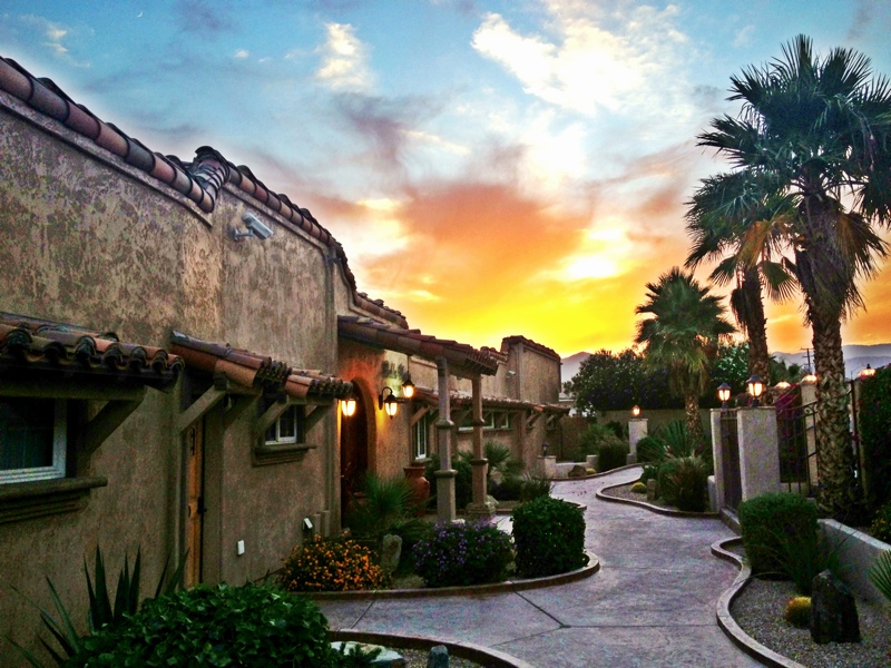The outside of Bella Monte Recovery Center, a Spanish style building in the desert, in front of a brilliant sky