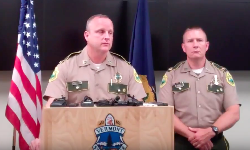 Two Vermont state policemen in the middle of a press conference