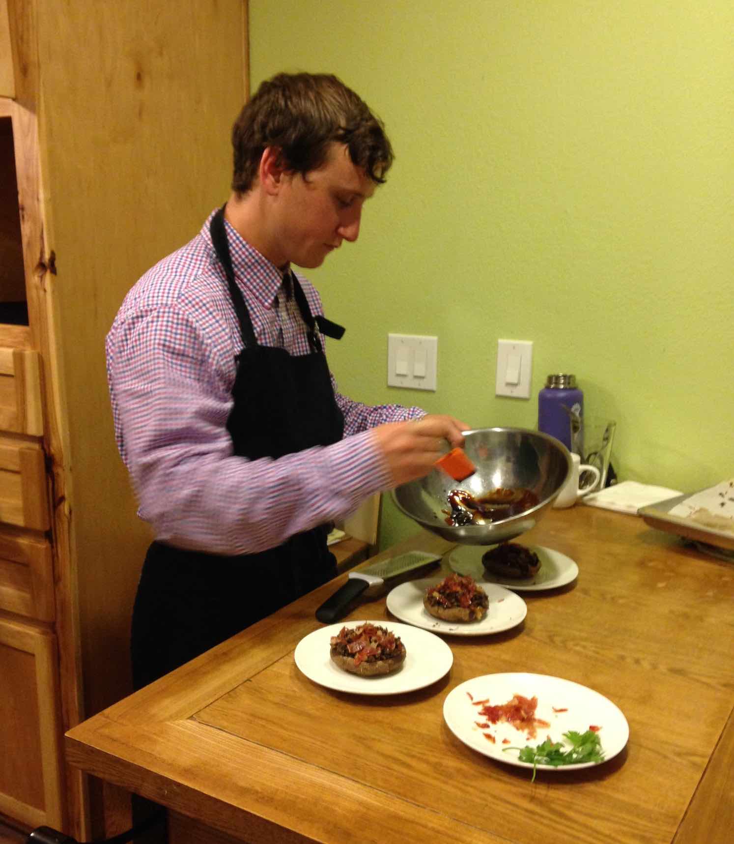 A young man prepares food as part of the culinary program