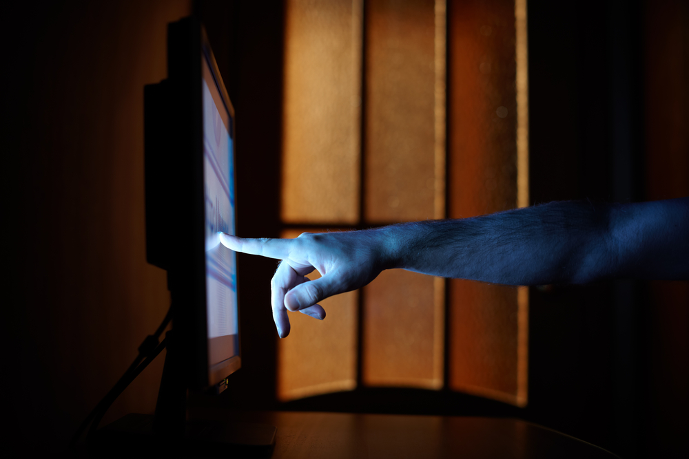 hand pointing to a computer screen