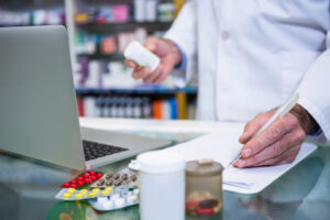 Pharmacist writing prescriptions for medicines in pharmacy