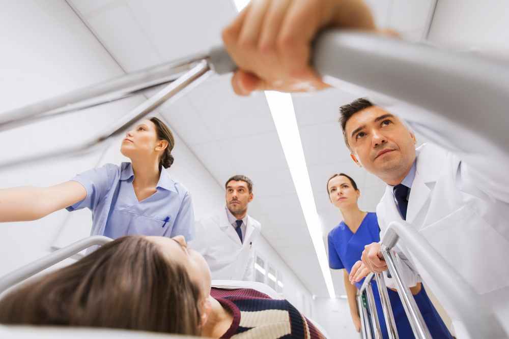 emergency room specialists pushing a bed through the halls