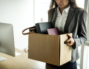 Businesswoman holding a box of her belongings.