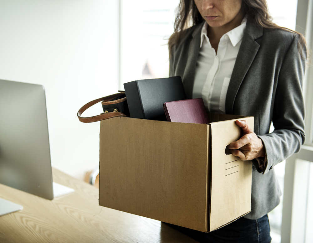 Businesswoman holding a box of her belongings.