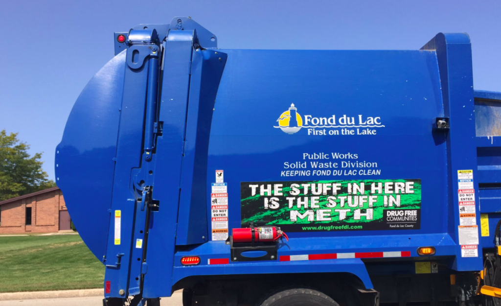 garbage truck with the crystal meth awareness sign