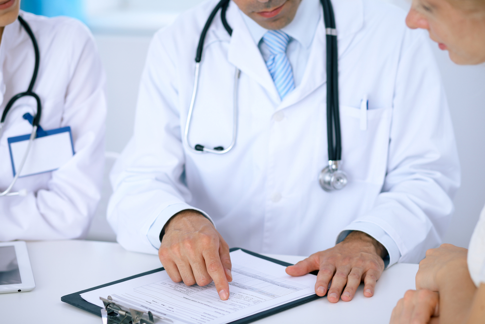 Doctor and patient reviewing a medical history form.