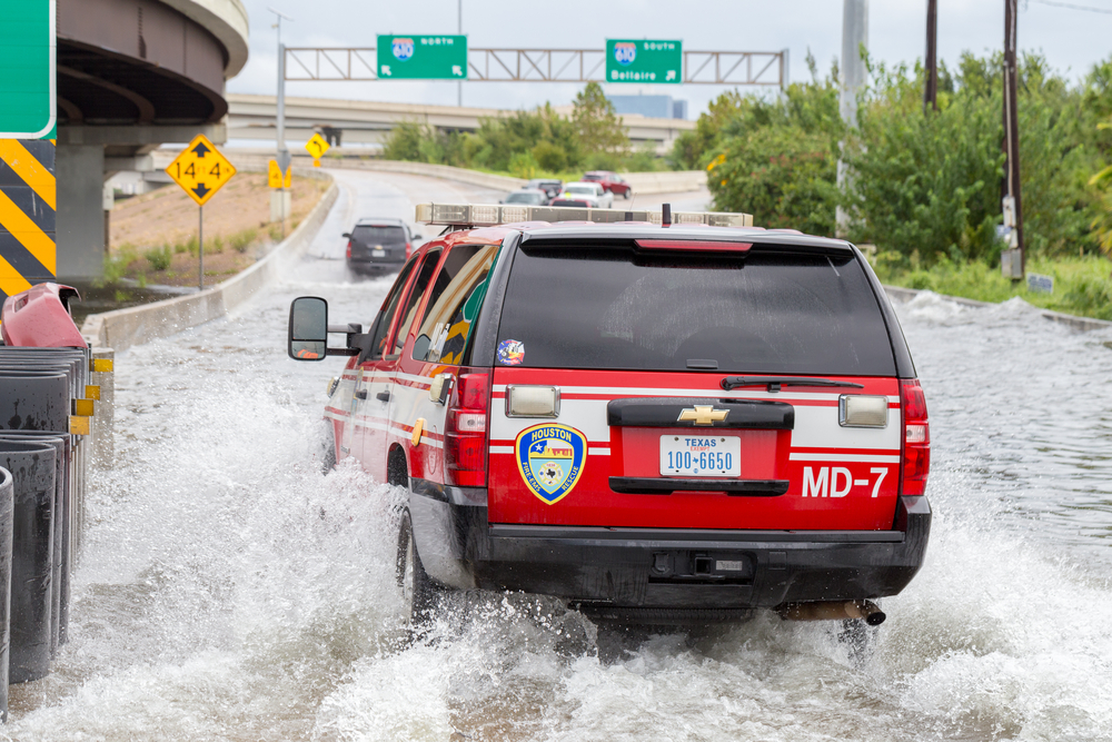 Houston emergency services with cars across the flooded street in Houston, Texas, US