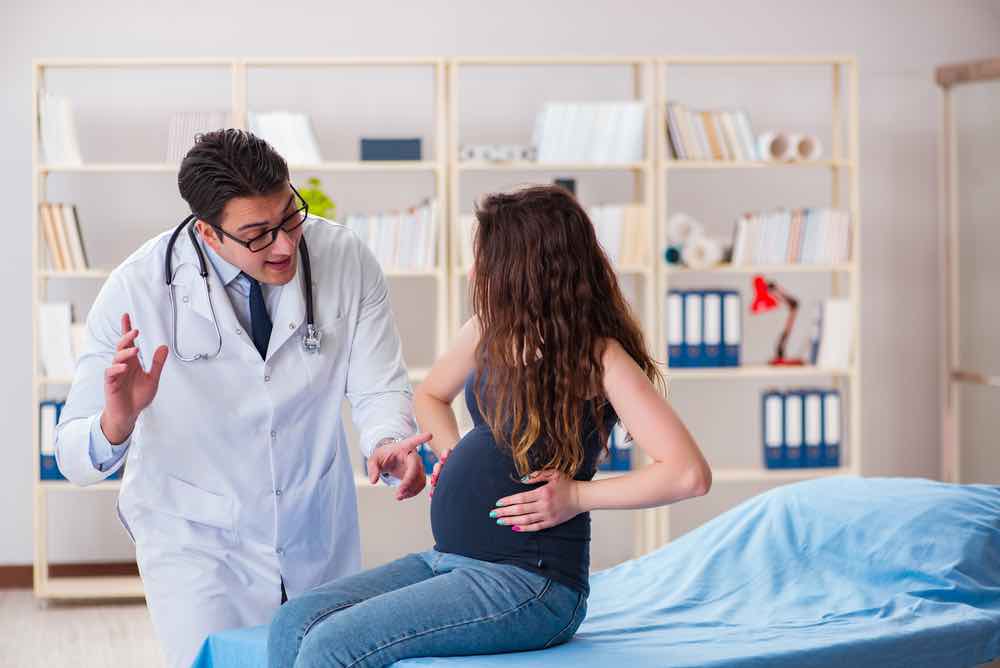 Pregnant woman with doctor
