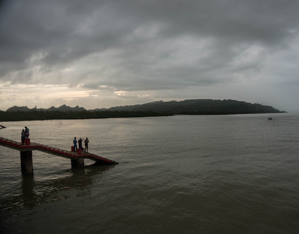 3 people on a pier in Bangladesh