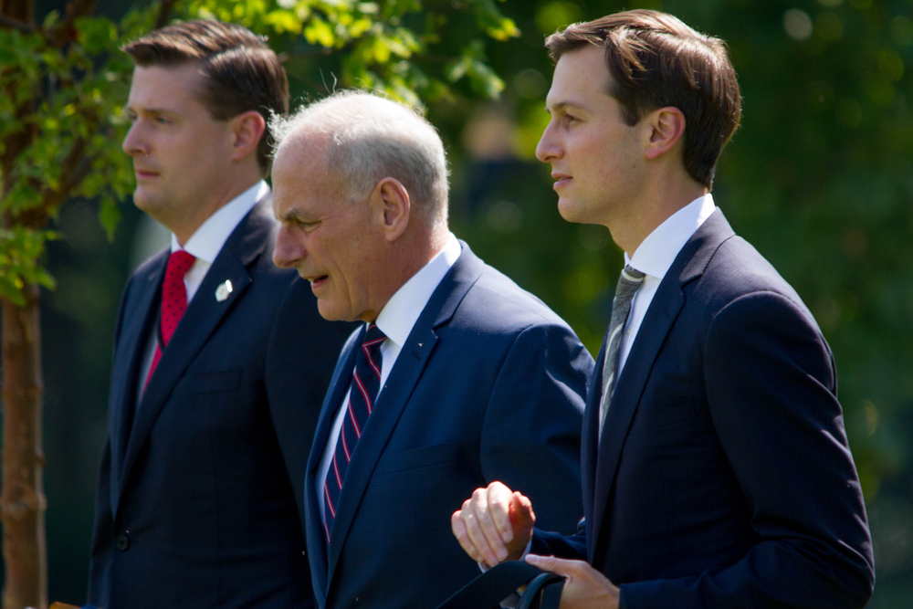 John Kelly walks with Rob Porter and Jared Kushner.